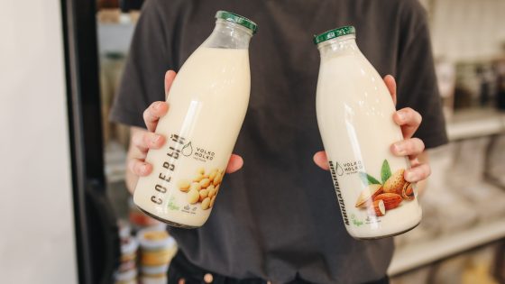 Person holding bottles with milk